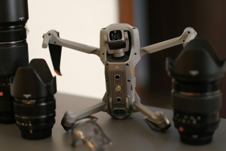 Detailed close-up of a drone and camera lenses on a table, focusing on photography tools.