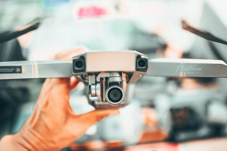 Detailed shot of a drone being held, focusing on its camera and design elements.